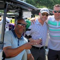 3 men wait by golf cart